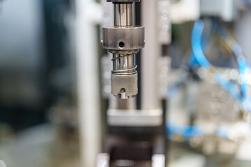 Precision tool used in machine for manufacturing parts in a workshop setting with focused equipment and components