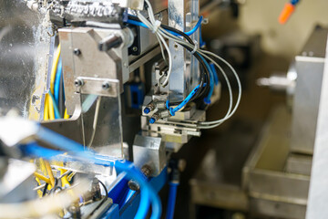 Close view of industrial machine components during operation in a manufacturing facility in the afternoon