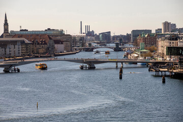 Water Bus (yellow ferry) sailing on canal on the outskirts of Copenhagen, Denmark