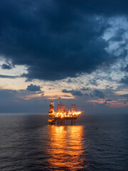 Offshore jack up rig in aerial view in the middle of the ocean taken by a drone