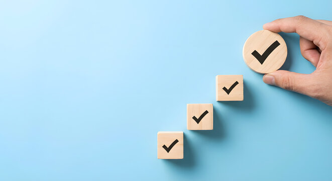 wooden blocks with checkmarks in hand on blue background