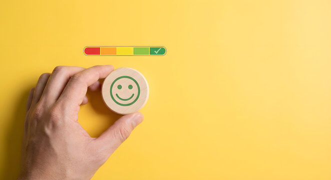 hand holding smiling face token with satisfaction rating