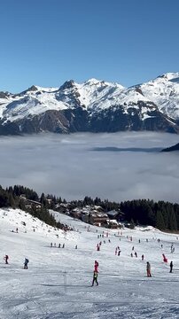 Aerial view Courchevel ski resort under clouds by winter, Rh&ocirc;ne alps, France, Mont Blanc mountain in the background	
