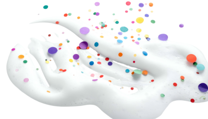 Swirling white substance with colorful confetti-like shapes scattered on it