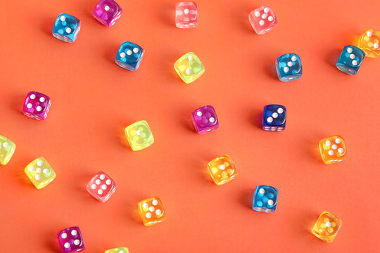 Colorful game dices on orange background