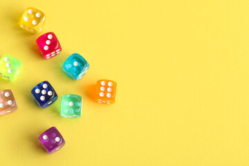 Fototapeta premium Colorful game dices on yellow background