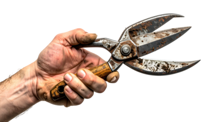 Close-up of a weathered hand holding rusty garden shears against a black background