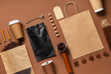 Composition with coffee set, craft paper and delivery bag on brown background