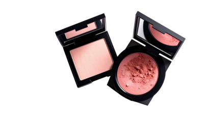 Two open compacts, one with smooth powder, the other with textured blush, on black