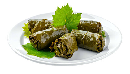 A white plate holds delicious dolma, stuffed grape leaves. Fresh leaves garnish the dish