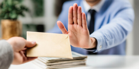 A businessman refuses a bribe and makes a "stop" gesture. The concept of honesty in business.