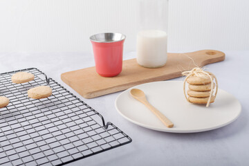 A bag of homemade cookies, a bottle of milk, and a cup of coffee.