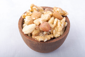 Rustic wooden bowl with a mix of nuts.