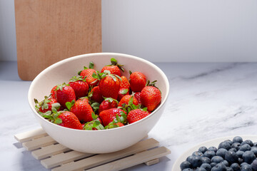 Container with several fresh strawberries.