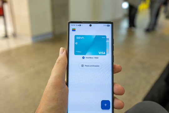 Porto, portugal; 12 28 2025 hand holding smartphone showing bbva visa digital debit card