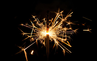 Sparkler fireworks close up on dark background. New Year celebration concept.