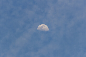 Moon in the blue sky with white clouds, 
