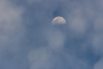 Moon in the blue sky with white clouds, 