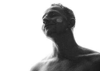 Portrait, facial or lotion with a shirtless man in studio