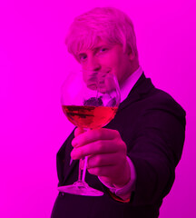 Man tasting a glass of red wine. Man wine glass. Drink. Happy day. Neon light