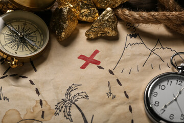 Treasure map with travel equipment and golden nuggets, closeup © Pixel-Shot