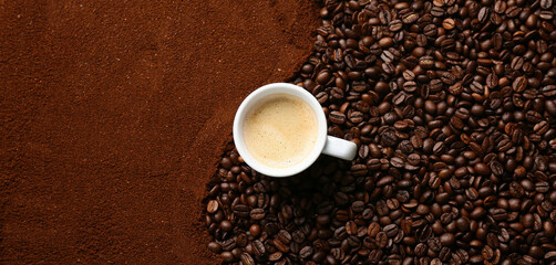 Composition with coffee powder, roasted beans and cup of hot beverage