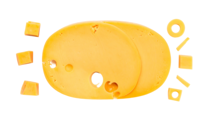 Overhead shot of yellow dairy product slices, cubes, and a ring, set on black background