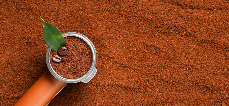 Portafilter with beans and coffee powder, closeup