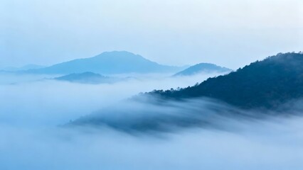 Misty mountain landscape with fog-covered peaks and serene blue tones