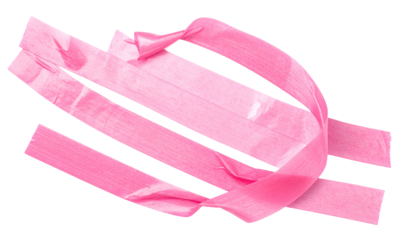 Close-up of intertwined pink tape strips against a stark black background