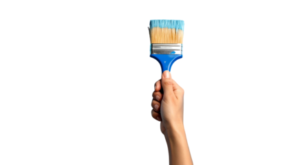 Hand holding a paintbrush with blue paint, against a black background