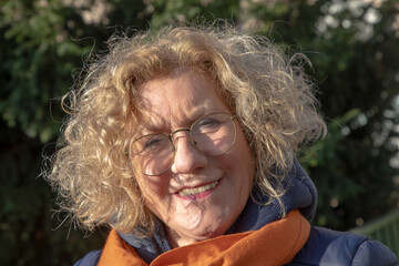 outdoor portrait of very attractive mature woman smiling