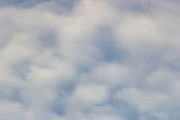 The moon in the blue sky and white clouds on a sunny day