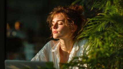 Serene Woman Relaxing in Natural Light with Laptop in Sunny Interior