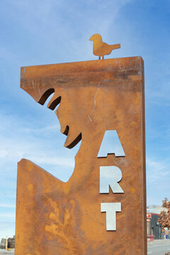 iron sculpture with iron bird on top in Denver