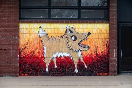 colorful mural at an old brick wall.
