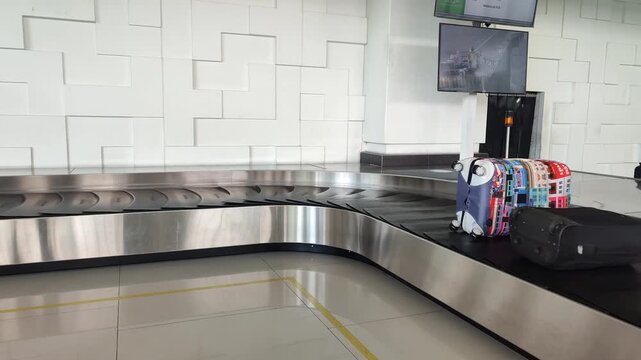 Empty conveyor belt in the baggage claim area of international airport. Waiting for bags and backpacks moves at rubber carousel belt
