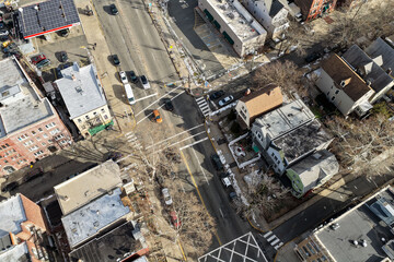 Aerial drone views looking straight down over Jersey City streets reveal dense urban patterns, intersecting roads, rooftops, and city blocks, showcasing the scale, layout, and everyday rhythm of a mod