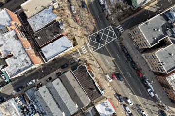 Aerial drone views looking straight down over Jersey City streets reveal dense urban patterns, intersecting roads, rooftops, and city blocks, showcasing the scale, layout, and everyday rhythm of a mod