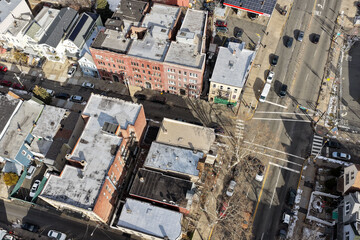 Aerial drone views looking straight down over Jersey City streets reveal dense urban patterns, intersecting roads, rooftops, and city blocks, showcasing the scale, layout, and everyday rhythm of a mod
