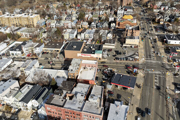 Aerial drone views looking straight down over Jersey City streets reveal dense urban patterns, intersecting roads, rooftops, and city blocks, showcasing the scale, layout, and everyday rhythm of a mod