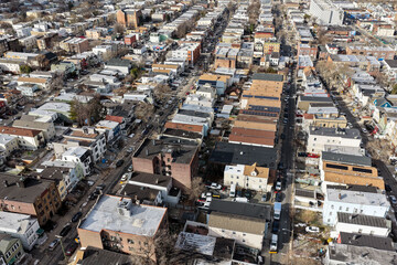 Aerial drone views looking straight down over Jersey City streets reveal dense urban patterns, intersecting roads, rooftops, and city blocks, showcasing the scale, layout, and everyday rhythm of a mod