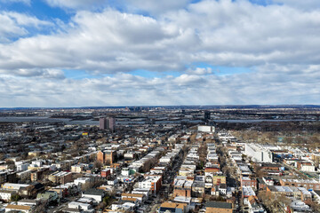 Aerial drone views looking straight down over Jersey City streets reveal dense urban patterns, intersecting roads, rooftops, and city blocks, showcasing the scale, layout, and everyday rhythm of a mod
