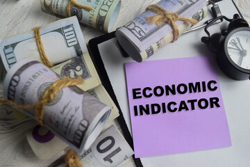 Concept of economic indicator write on sticky notes isolated on Wooden Table.