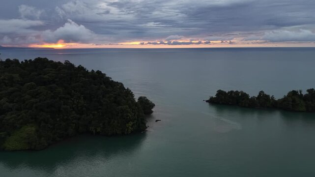 Aerial sunset view of tropical jungle and Pacific Ocean coastline in Nuqui, Colombia