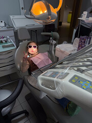 Young Patient Confidently Giving Peace Sign While Enjoying Pediatric Dental Checkup In Bright Environment