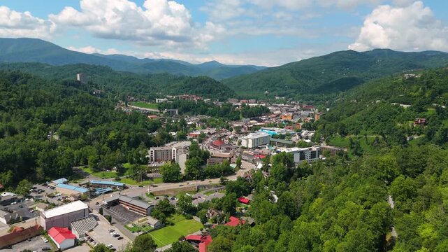 Aerial panorama of Gatlinburg, Tennessee with observation tower, town tourist infrastructure and Smoky Mountains National Park nearby.