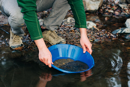 Gold Panning in Mountain Creek Using Blue Pan