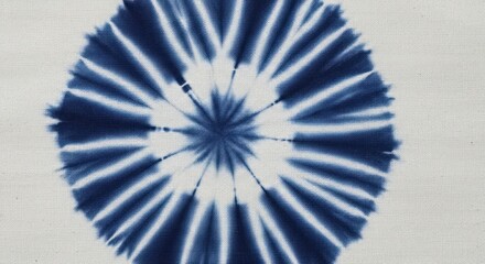 Close-up of a blue and white tie-dye pattern on a fabric with a circular design.