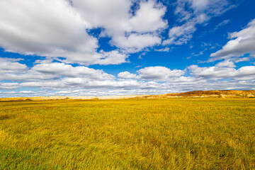  Beautiful prairie landscape at Badlands National Park on a sunny with clouds autumn day.